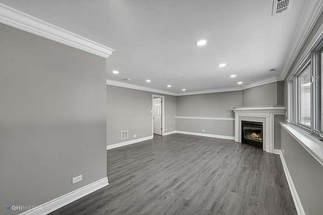 unfurnished living room with dark wood-type flooring and crown molding