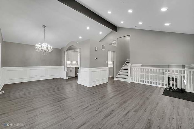 unfurnished living room featuring lofted ceiling and dark hardwood / wood-style floors