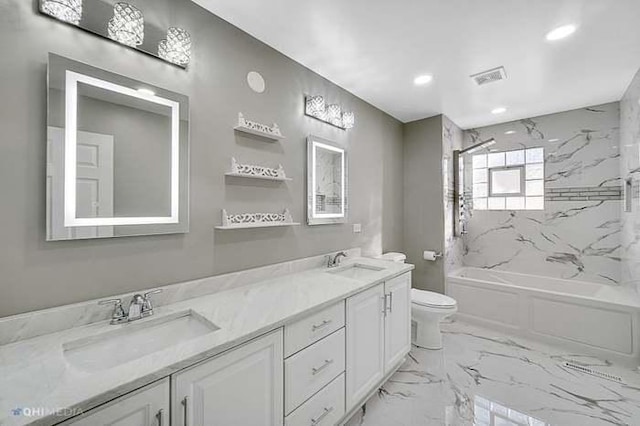 full bathroom with vanity, tiled shower / bath combo, and toilet