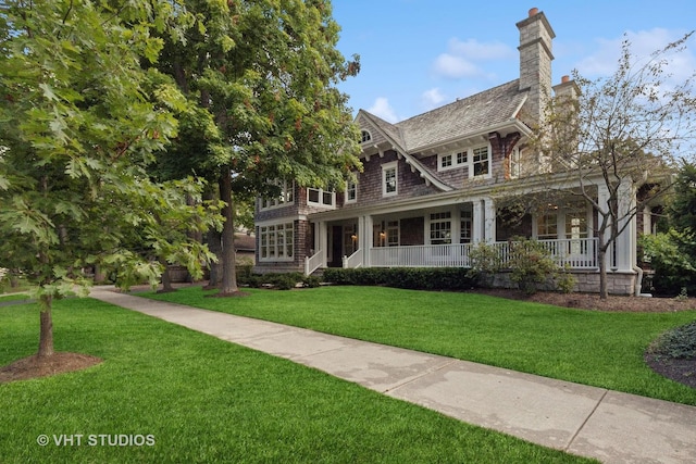 view of front of home with a porch and a front yard