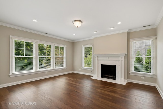 unfurnished living room featuring a wealth of natural light, dark hardwood / wood-style floors, and a premium fireplace