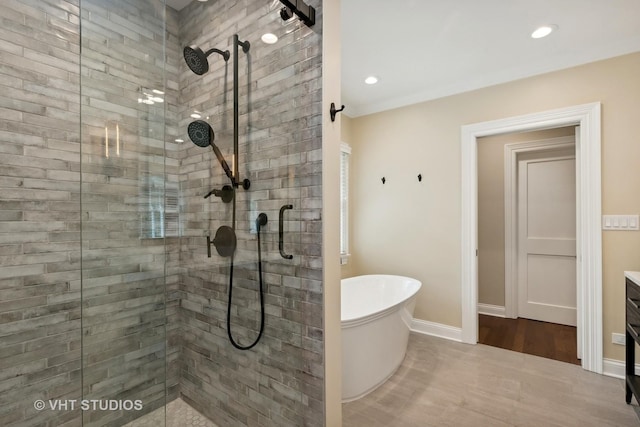 bathroom featuring tile patterned floors, vanity, and shower with separate bathtub