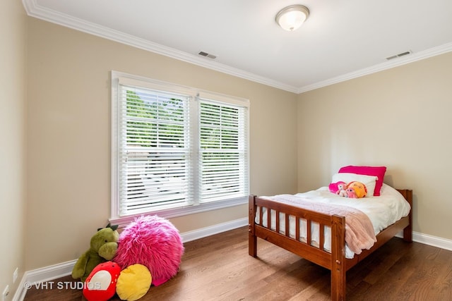 bedroom featuring dark hardwood / wood-style flooring, ornamental molding, and multiple windows