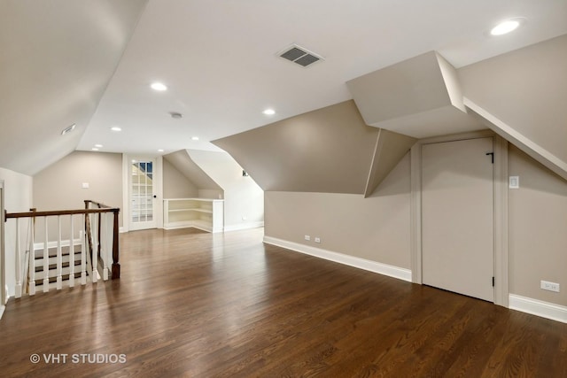 bonus room featuring dark wood-type flooring and lofted ceiling