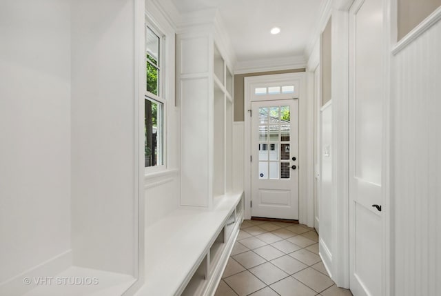 mudroom with light tile patterned floors and ornamental molding