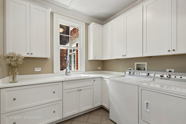 laundry room featuring washer and dryer, light tile patterned flooring, cabinets, ornamental molding, and sink