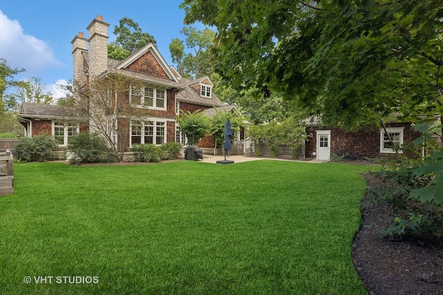 back of house featuring a patio area and a yard