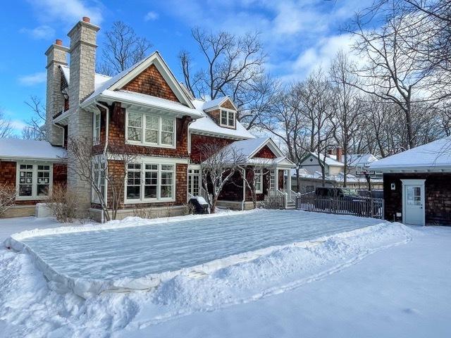 view of snow covered rear of property