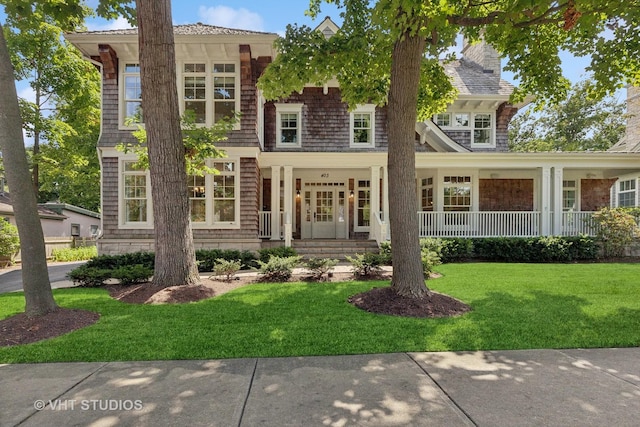 view of front of property with covered porch and a front yard