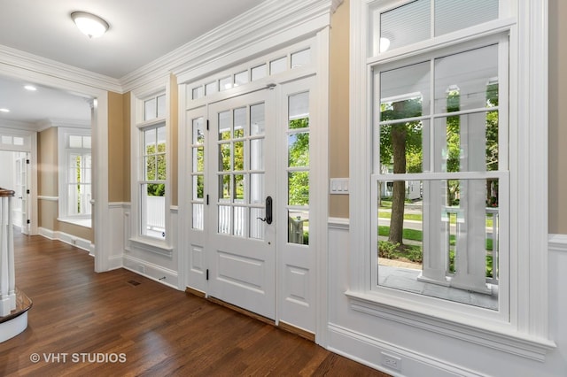 doorway to outside with dark hardwood / wood-style flooring and crown molding