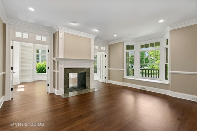 unfurnished living room with a fireplace, dark hardwood / wood-style flooring, and crown molding