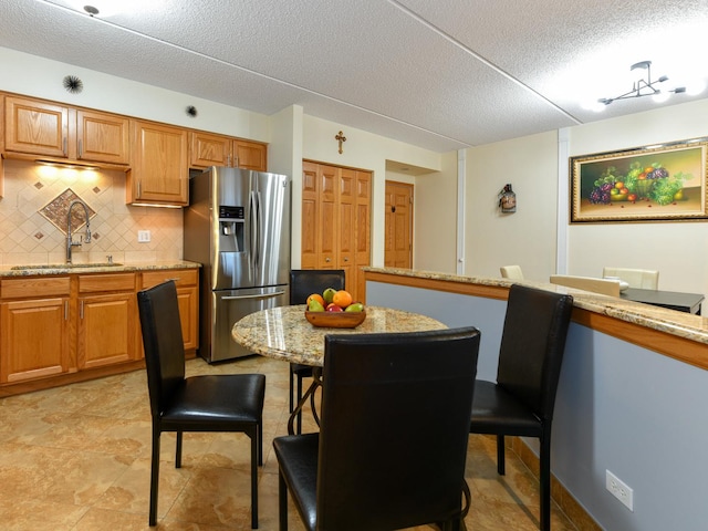 dining area with a textured ceiling and sink