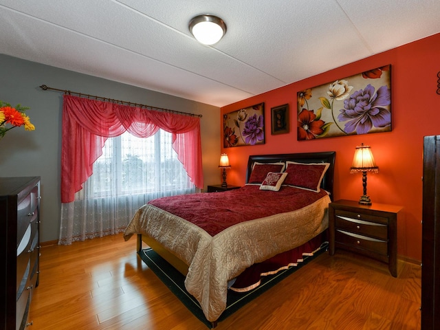 bedroom with hardwood / wood-style floors