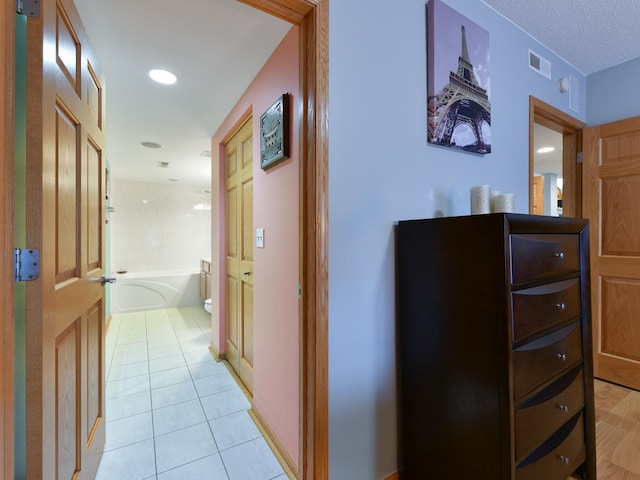 hall featuring light tile patterned floors