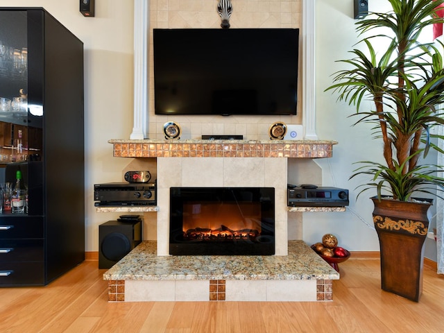 interior details with hardwood / wood-style flooring and a fireplace