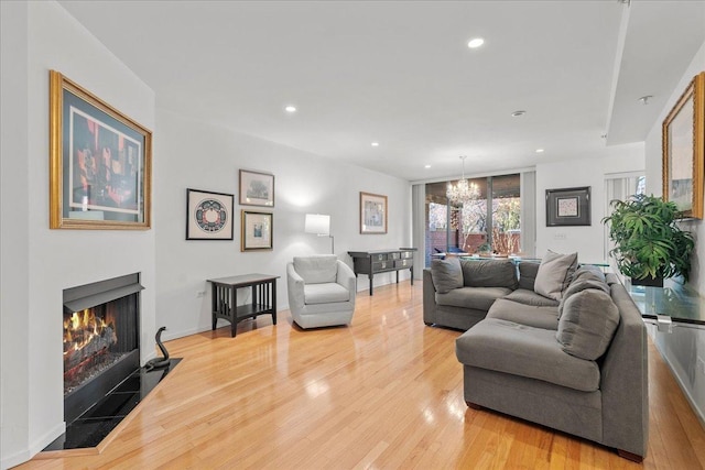 living room with a chandelier and hardwood / wood-style floors