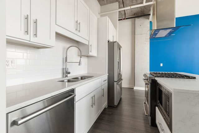 kitchen featuring exhaust hood, appliances with stainless steel finishes, white cabinetry, and sink