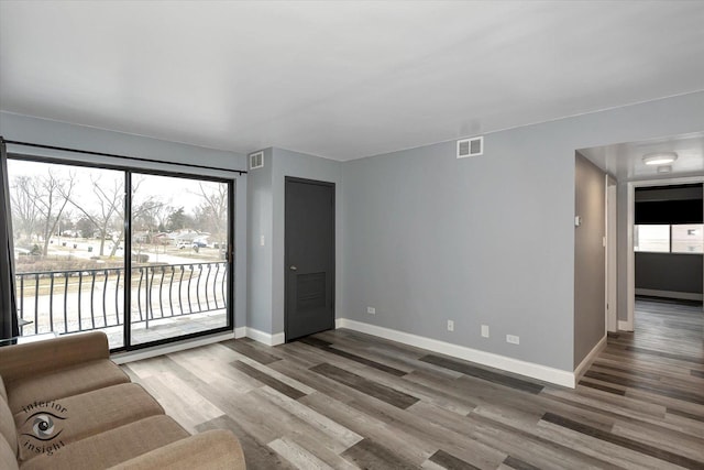 unfurnished living room with wood-type flooring