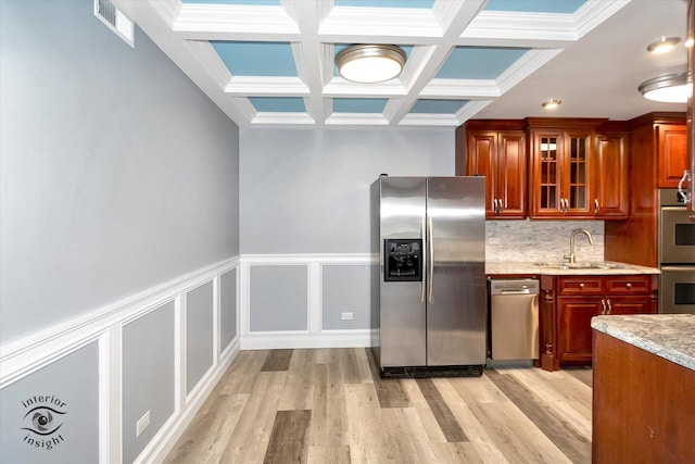 kitchen featuring beam ceiling, sink, coffered ceiling, light hardwood / wood-style flooring, and appliances with stainless steel finishes