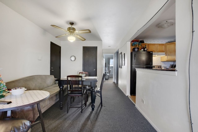 carpeted dining area featuring ceiling fan