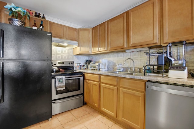 kitchen featuring backsplash, sink, light tile patterned floors, and appliances with stainless steel finishes