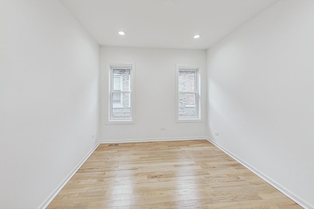 spare room featuring light hardwood / wood-style flooring