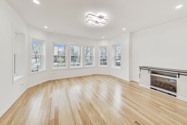 unfurnished living room featuring light hardwood / wood-style flooring