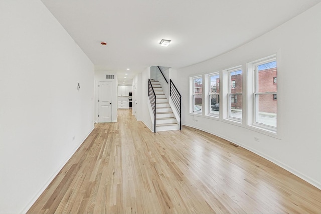 unfurnished living room with light wood-type flooring