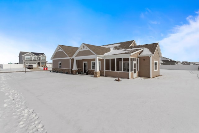 back of house featuring a sunroom