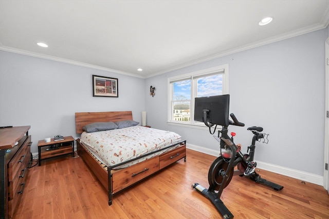 bedroom featuring light hardwood / wood-style floors and crown molding