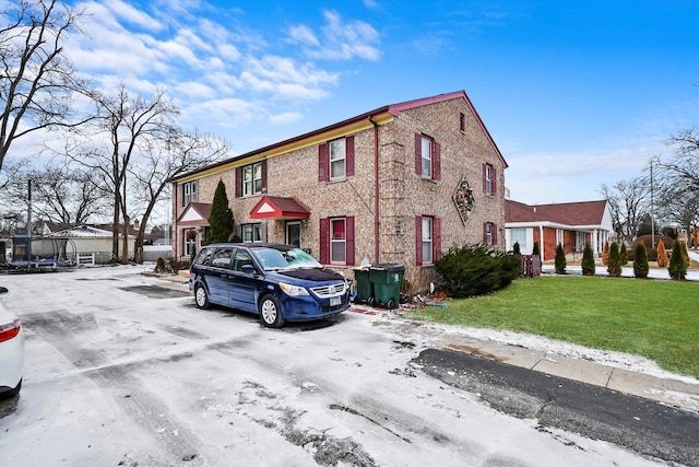 view of front of house featuring a front lawn and a trampoline