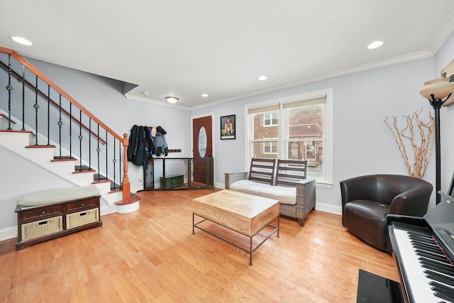 living room featuring light hardwood / wood-style floors and ornamental molding