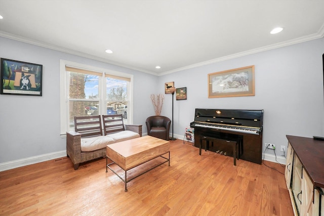 living area featuring light hardwood / wood-style floors and crown molding