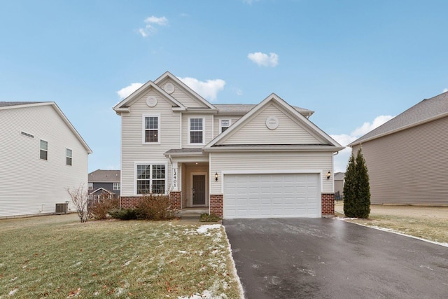 view of front of home with a garage, central AC unit, and a front yard