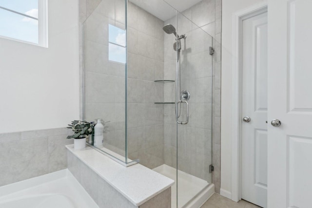 bathroom featuring shower with separate bathtub