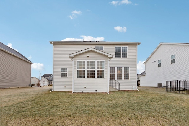 back of house featuring cooling unit and a yard