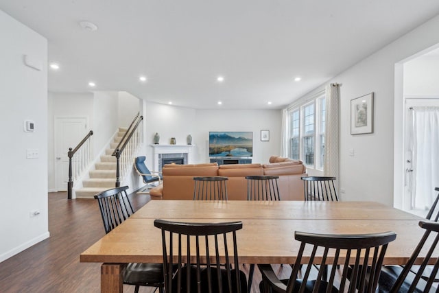 dining space with dark hardwood / wood-style flooring