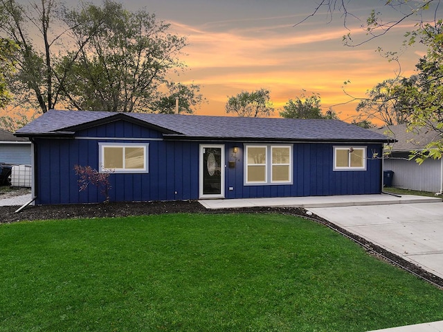 ranch-style house featuring a lawn