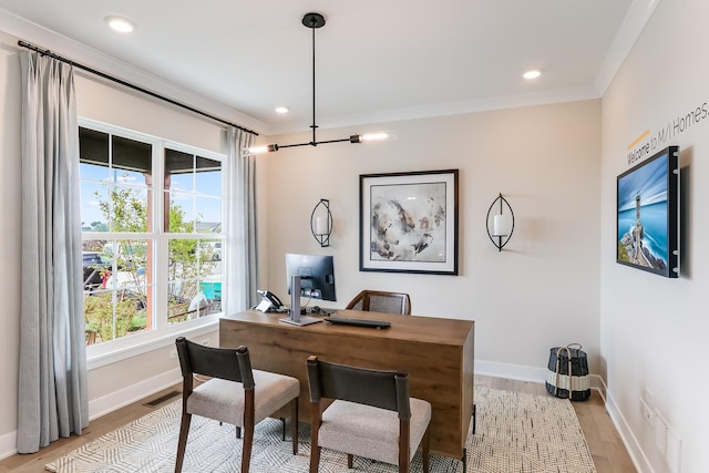 office space featuring crown molding and light hardwood / wood-style flooring