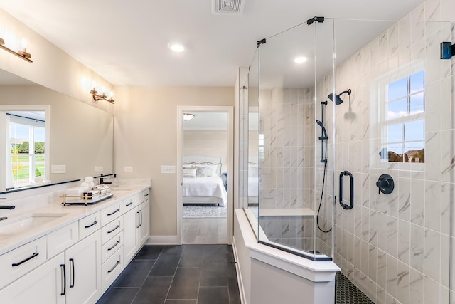 bathroom with tile patterned flooring, vanity, and a shower with shower door