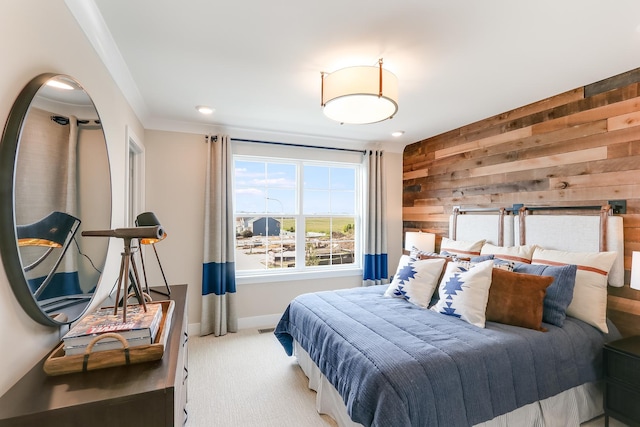 bedroom featuring carpet, ornamental molding, and wooden walls