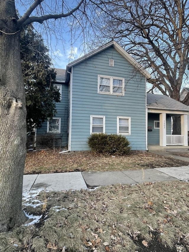 view of side of home with covered porch