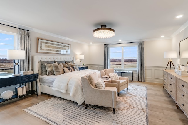 bedroom featuring light hardwood / wood-style floors, multiple windows, and ornamental molding