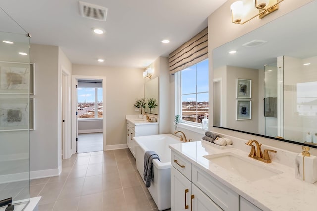 bathroom with tile patterned flooring, vanity, and an enclosed shower