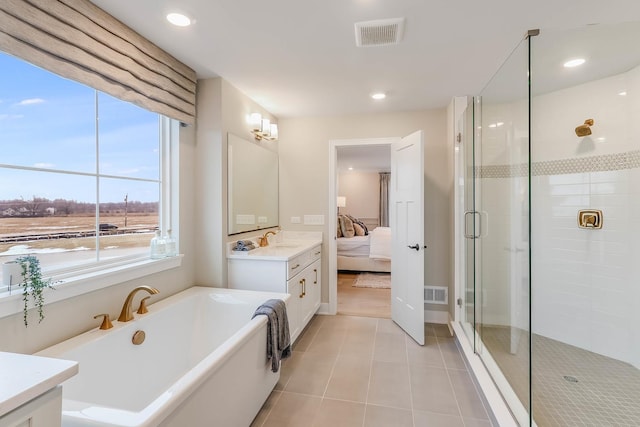 bathroom featuring tile patterned flooring, vanity, and plus walk in shower