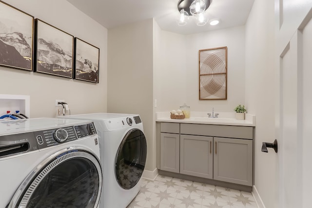 washroom with cabinets, separate washer and dryer, and sink