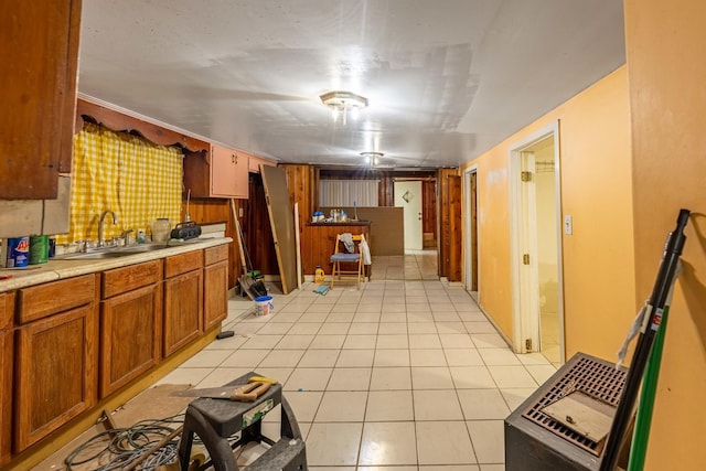 kitchen featuring light tile patterned floors and sink