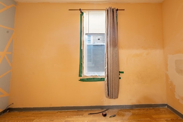 empty room with hardwood / wood-style floors