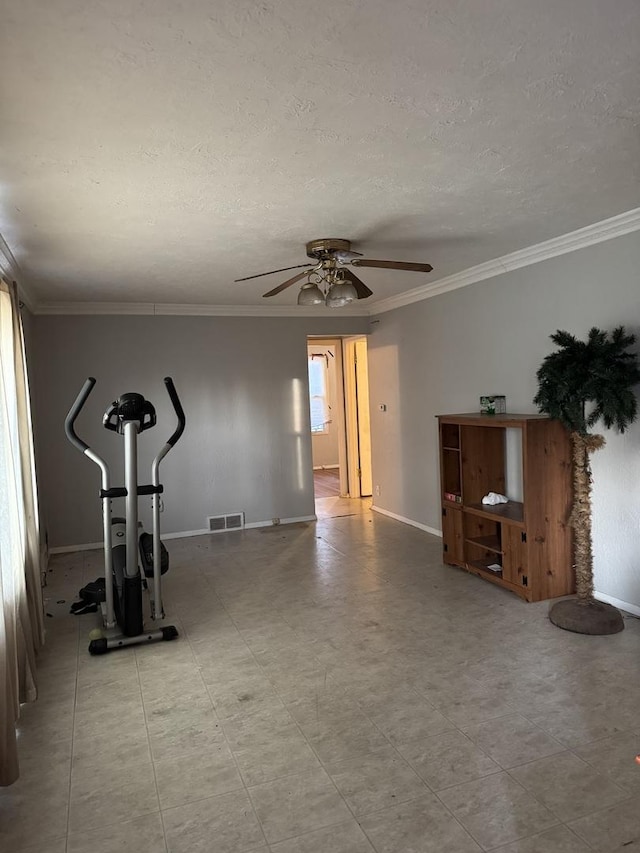 workout room with ceiling fan and crown molding