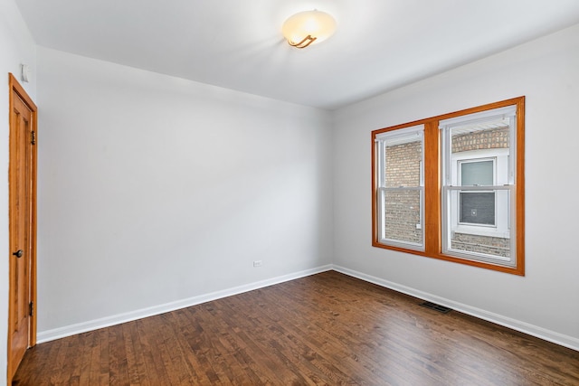 unfurnished room featuring dark hardwood / wood-style flooring